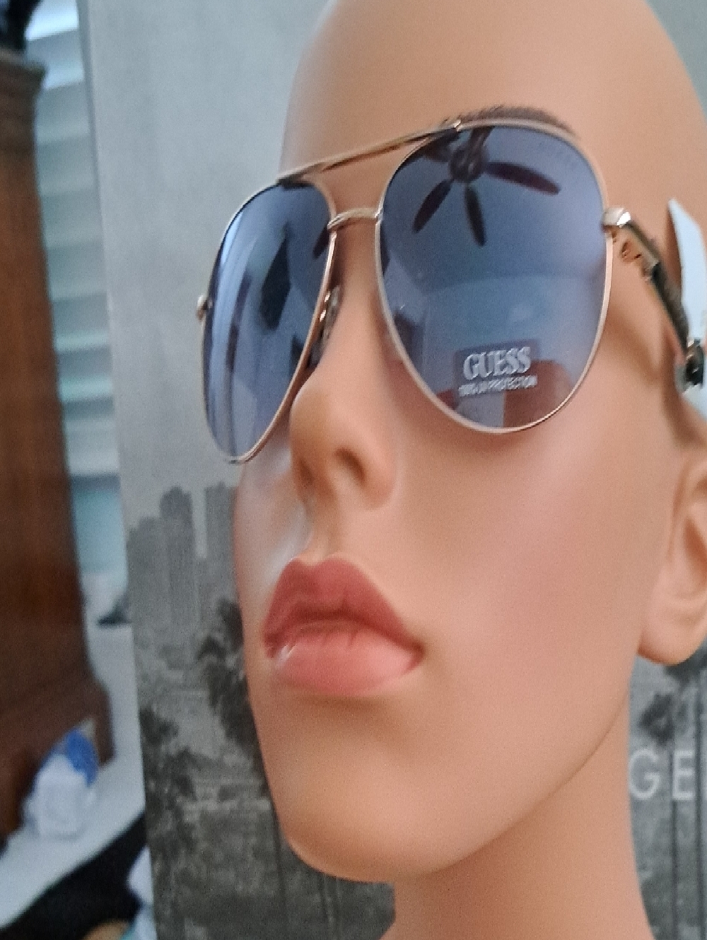 GUESS Gold Frame Sunglasses with Blue Lenses